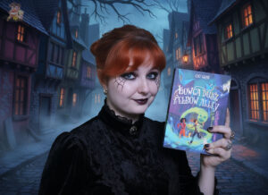 Recenzentka trzyma książkę Łowca dusz z Elbow Alley – klimat grozy, ulica we mgle, zapowiedź recenzji przygodowego dreszczowca dla dzieci