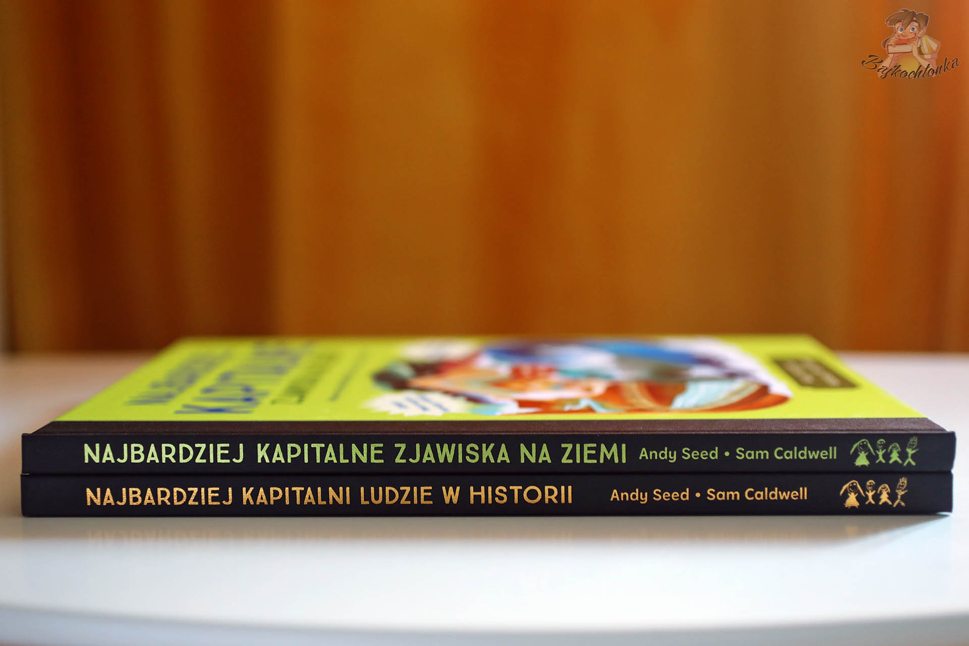 Grzbiety tomów Najbardziej kapitalne zjawiska na Ziemi i Najbardziej kapitalni ludzie w historii – duet All Kids Publishing