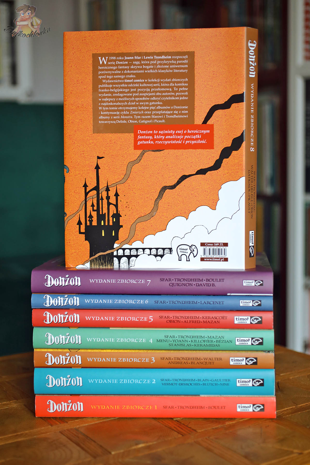 Tylna okładka komiksu Donżon. Wydanie zbiorcze 8 z opisem serii i grafiką zamku na tle pomarańczowego nieba.