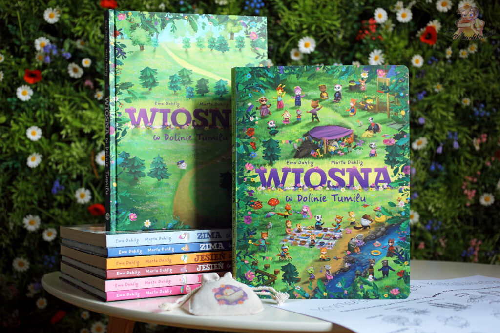 Wiosna w Dolinie Tumilu książki na tle kwiatów aranżacja