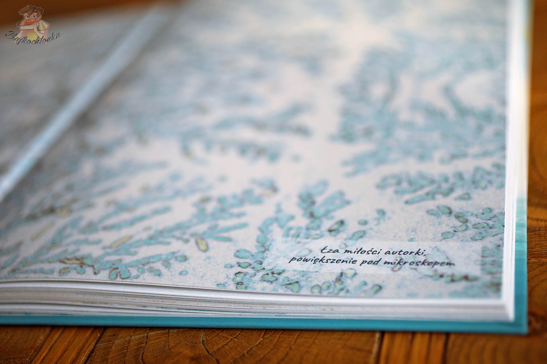 Zbliżenie na ilustrację łzy miłości autorki w powiększeniu pod mikroskopem z książki Połezja