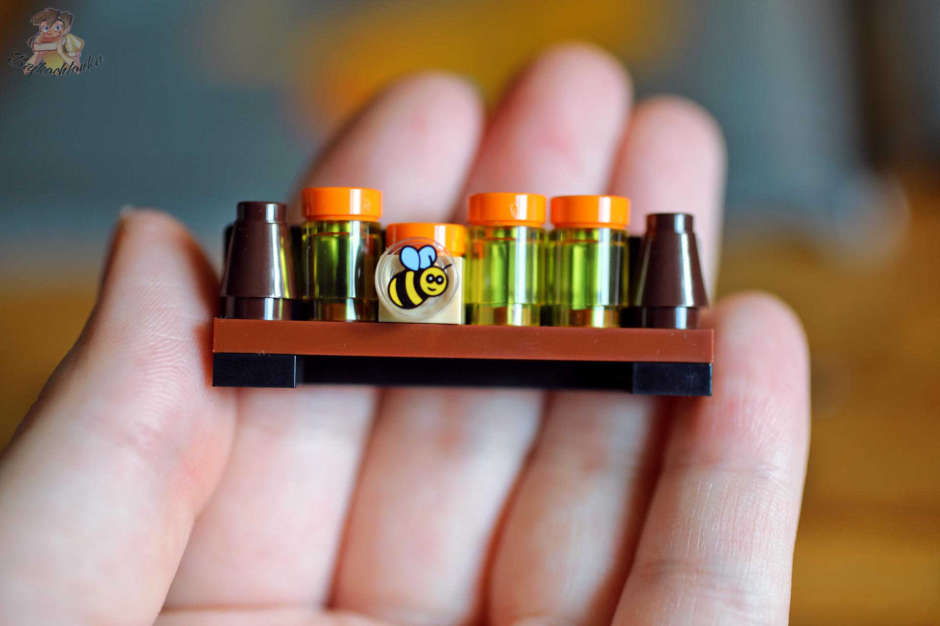 Miniaturowe słoiczki z miodem i element z pszczołą z zestawu LEGO® Kubuś Puchatek