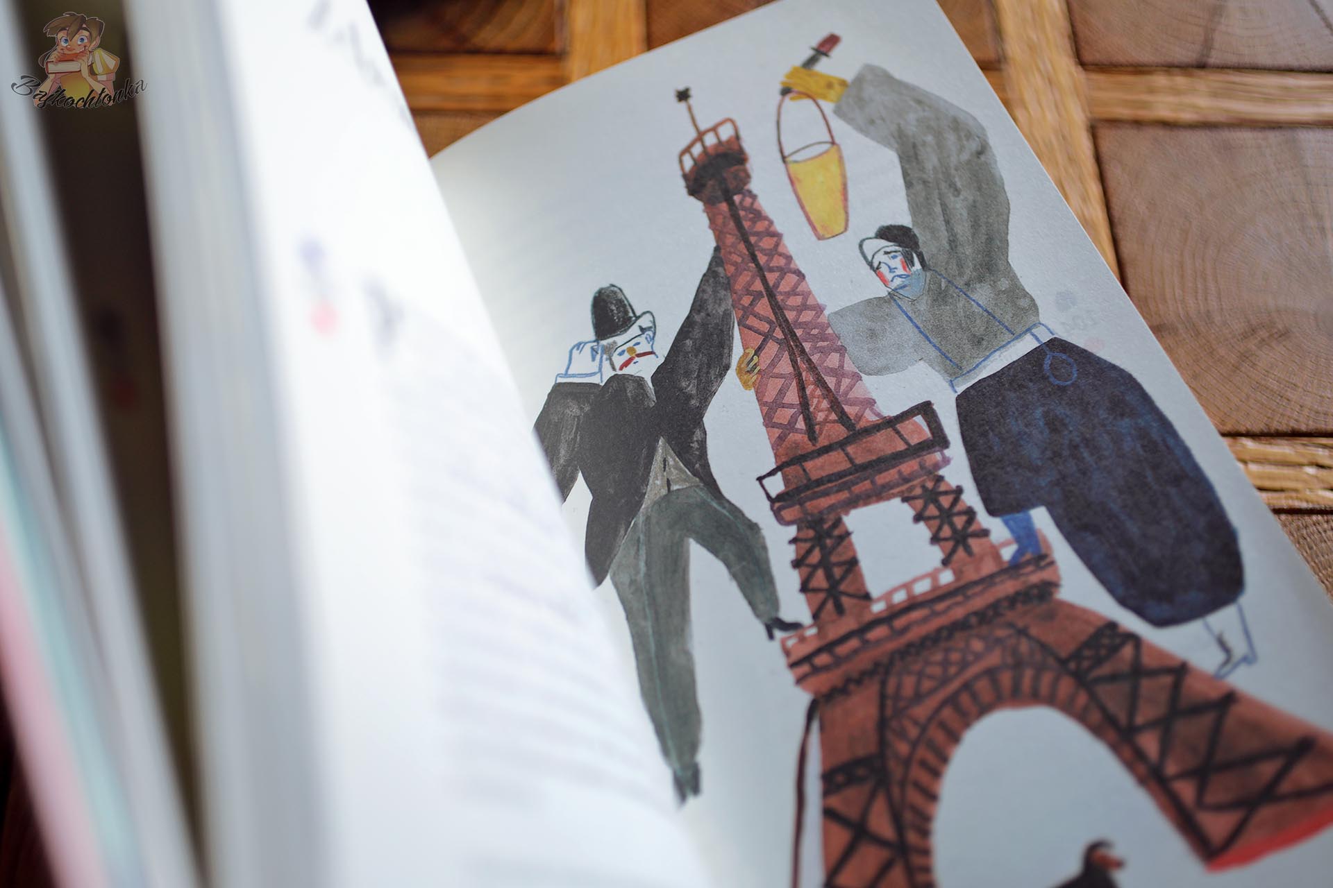 Malarska ilustracja wieży Eiffla i postaci w Paryżu autorstwa Julii Bardziejewskiej w książce Oh la la!